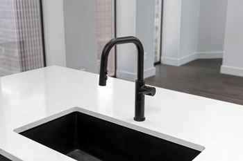 A kitchen sink with a tap in a 555 waverly unit